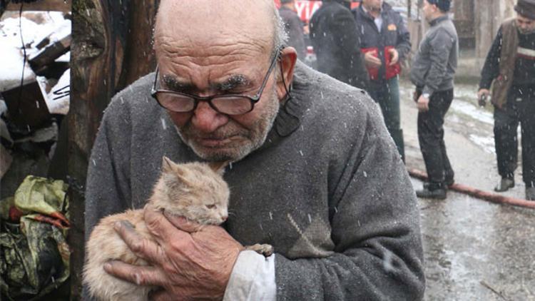 Sobayı benzinle tutuştururken evi yandı... Kedisine sarılarak izledi
