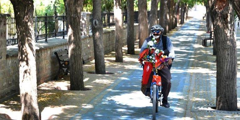 Bayrak ve çiçeklerle süslediği 'yol arkadaşı'nın 30 yıldır pedalını çeviriyor