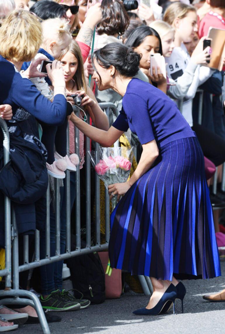 Kate dressed in colour, Meghan sweated profusely