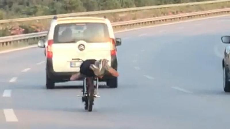Trafikte tepki çeken olay! Motosikleti yüzüstü yatarak kullandı
